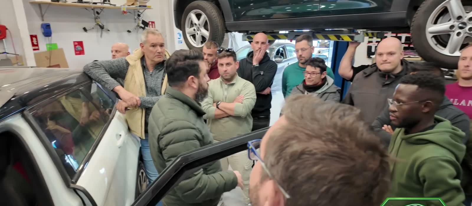Technicians around a Mercedes during a Diatronik dealer-level diagnostic training session